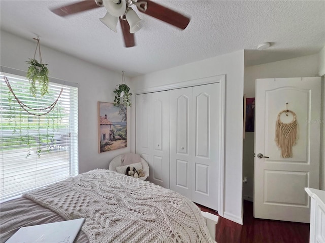 3897 NW 22nd Ave, Okeechobee, FL 34972 - bedroom with a closet, a textured ceiling, dark wood-type flooring, and ceiling fan