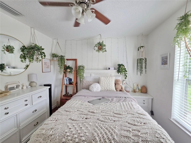 3897 NW 22nd Ave, Okeechobee, FL 34972 - bedroom with a textured ceiling, multiple windows, and ceiling fan