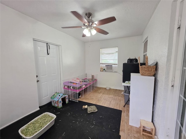 3897 NW 22nd Ave, Okeechobee, FL 34972 - rec room featuring wood finished floors, a ceiling fan, cooling unit, and baseboards