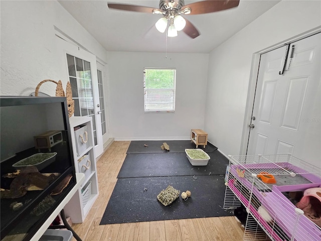 3897 NW 22nd Ave, Okeechobee, FL 34972 - rec room featuring wood finished floors, a ceiling fan, and baseboards