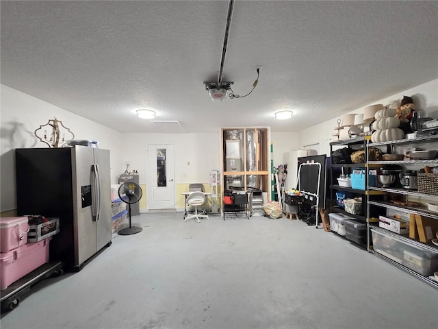 3897 NW 22nd Ave, Okeechobee, FL 34972 - garage featuring stainless steel fridge, washer / clothes dryer, and a garage door opener