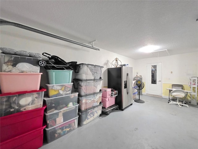 3897 NW 22nd Ave, Okeechobee, FL 34972 - basement featuring stainless steel refrigerator with ice dispenser, a textured ceiling, and washer / clothes dryer