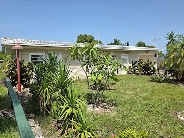 1209 5th St, Okeechobee, FL 34974 - view of grassy yard featuring a garage