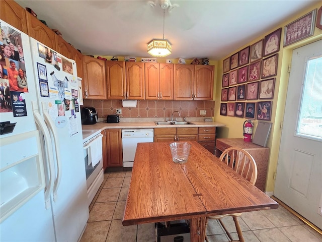 1209 5th St, Okeechobee, FL 34974 - kitchen featuring white appliances, a sink, light countertops, and light tile patterned floors
