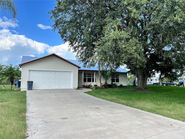 1150 SW 83rd Ave, Okeechobee, FL 34974 - single story home with concrete driveway, a front yard, an attached garage, and a metal roof