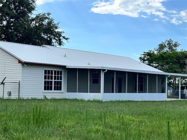 1150 SW 83rd Ave, Okeechobee, FL 34974 - back of property with a sunroom and a metal roof