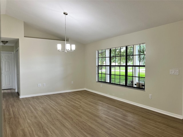 1150 SW 83rd Ave, Okeechobee, FL 34974 - spare room featuring lofted ceiling, dark wood-type flooring, and a chandelier