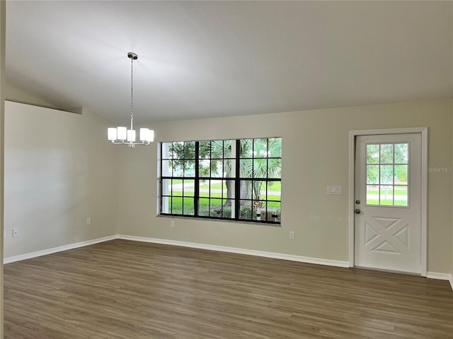 1150 SW 83rd Ave, Okeechobee, FL 34974 - unfurnished room with wood finished floors, a chandelier, healthy amount of natural light, and lofted ceiling