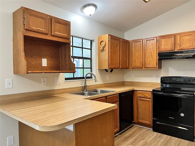 1150 SW 83rd Ave, Okeechobee, FL 34974 - kitchen featuring black appliances, under cabinet range hood, a peninsula, light countertops, and vaulted ceiling