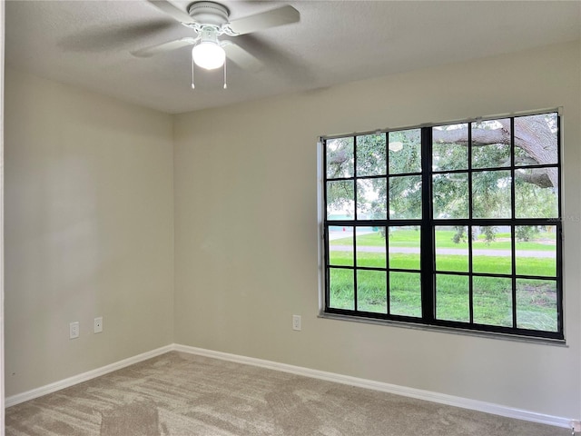 1150 SW 83rd Ave, Okeechobee, FL 34974 - unfurnished room featuring light carpet, ceiling fan, and healthy amount of natural light