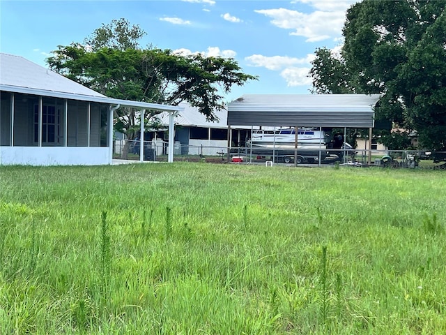 1150 SW 83rd Ave, Okeechobee, FL 34974 - view of yard featuring a carport and a sunroom