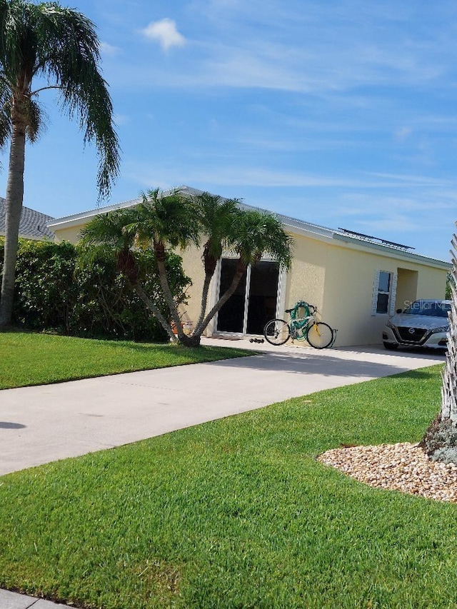 1000 SW 44th Blvd, Okeechobee, FL 34974 - view of front of house with stucco siding and a front lawn