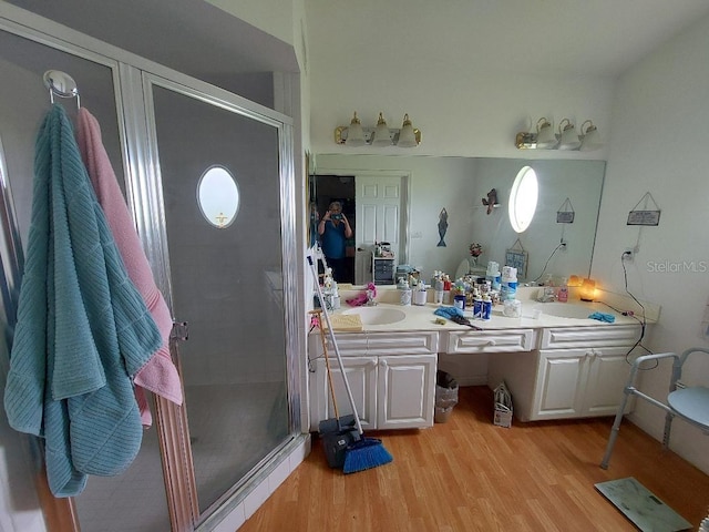 1000 SW 44th Blvd, Okeechobee, FL 34974 - bathroom featuring double vanity, a stall shower, and wood finished floors