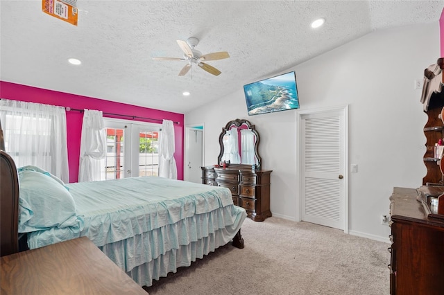 402 SW Seaflower Ter, Port St Lucie, FL 34984 - bedroom featuring access to outside, lofted ceiling, french doors, a textured ceiling, and carpet