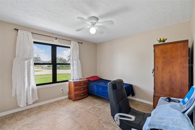 402 SW Seaflower Ter, Port St Lucie, FL 34984 - bedroom with a textured ceiling and a ceiling fan