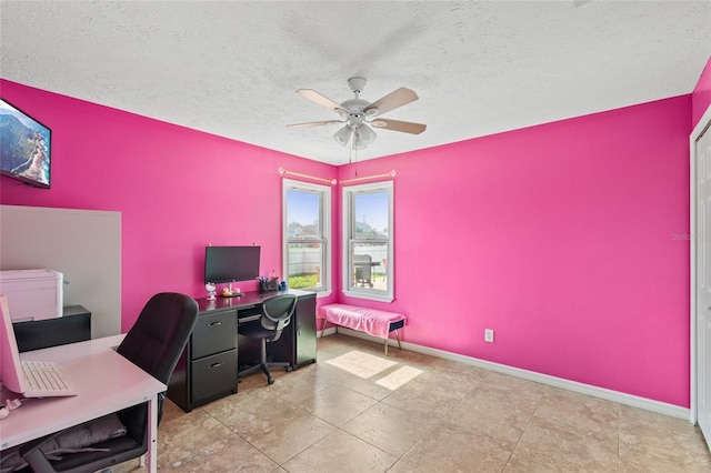 402 SW Seaflower Ter, Port St Lucie, FL 34984 - home office featuring a ceiling fan and a textured ceiling