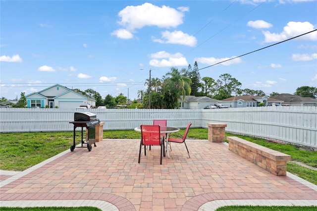 402 SW Seaflower Ter, Port St Lucie, FL 34984 - fenced backyard with a grill, outdoor dining area, and a patio