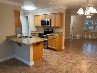 kitchen featuring pendant lighting, crown molding, a breakfast bar, stainless steel appliances, and an inviting chandelier