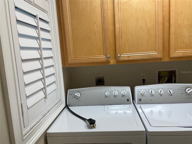 washroom featuring washer hookup, cabinets, separate washer and dryer, and electric dryer hookup