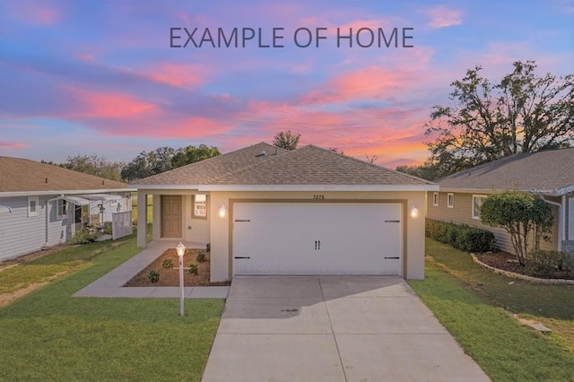 single story home featuring a lawn and a garage