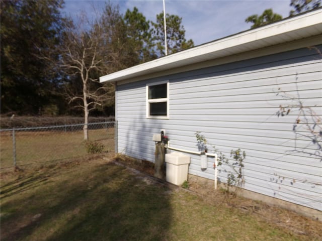 view of home's exterior with a yard