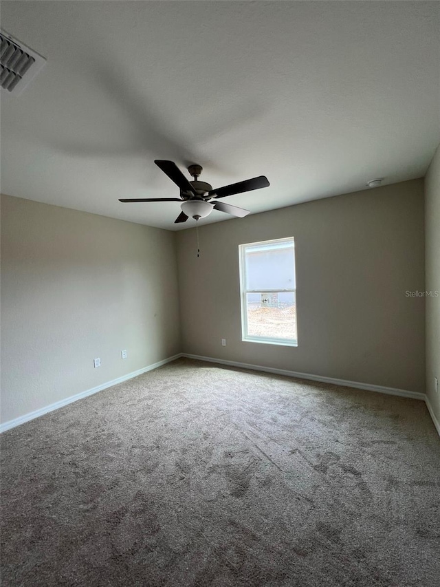 spare room with light carpet and ceiling fan