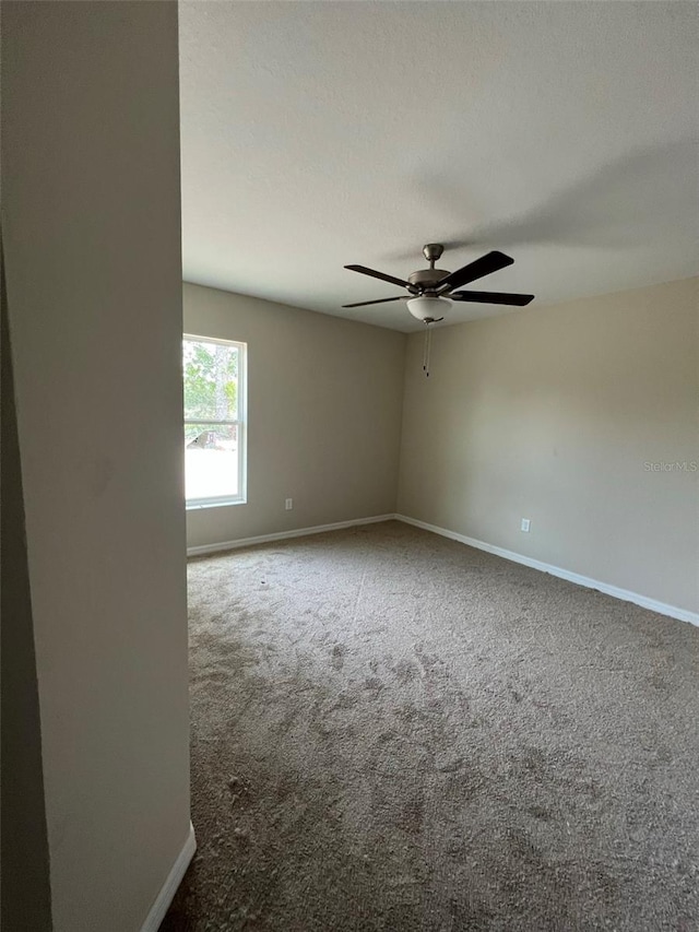 empty room with carpet and ceiling fan