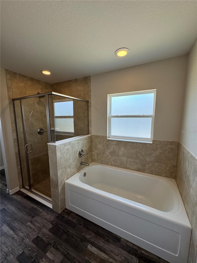 6711 SW 64th Ave, Ocala, FL 34476 - full bathroom with a shower stall, a bath, a textured ceiling, and wood finished floors