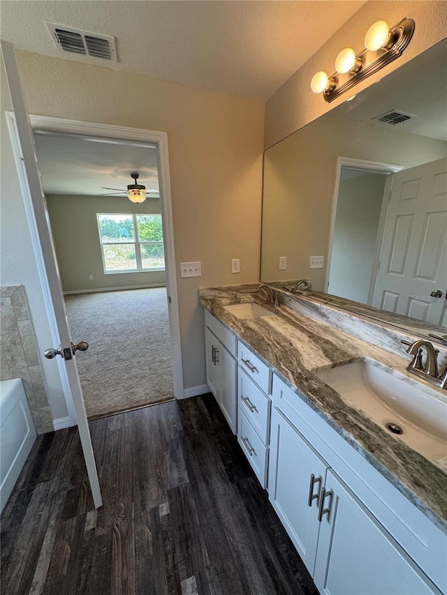 6711 SW 64th Ave, Ocala, FL 34476 - bathroom featuring double vanity, wood finished floors, visible vents, and a sink