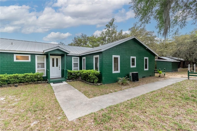 single story home featuring central AC unit and a front yard