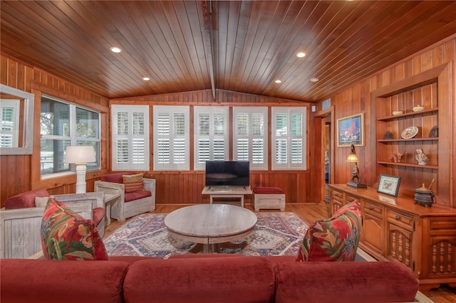 living room featuring plenty of natural light, wood ceiling, built in shelves, and lofted ceiling