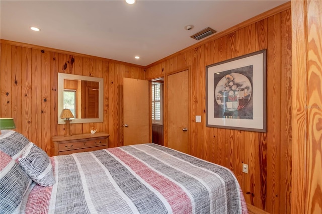 bedroom featuring wooden walls