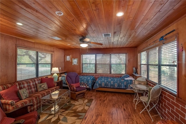 living room with wood walls, wood ceiling, dark hardwood / wood-style floors, and ceiling fan