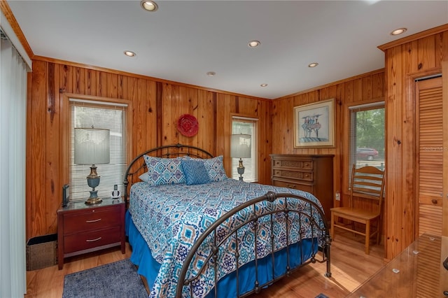 bedroom featuring wooden walls and light wood-type flooring