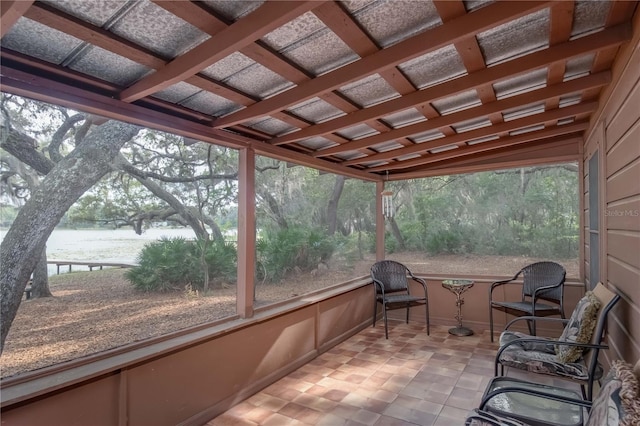 sunroom / solarium featuring coffered ceiling and lofted ceiling