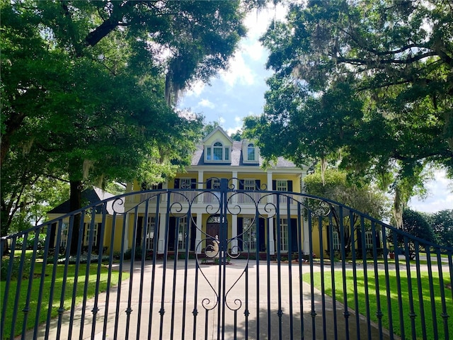 view of gate with a yard