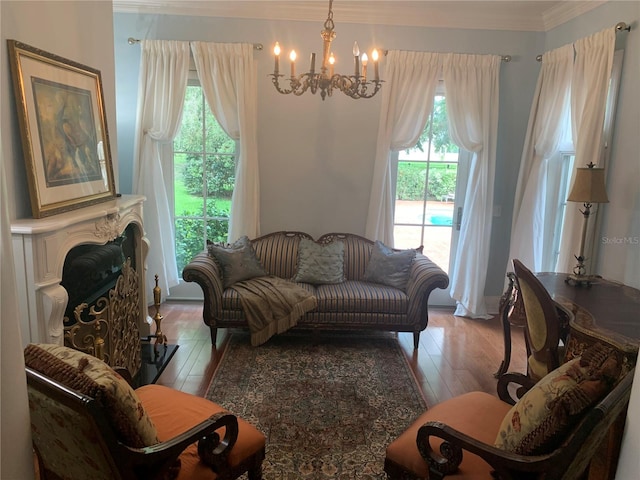 living room with ornamental molding, a chandelier, and light wood-type flooring