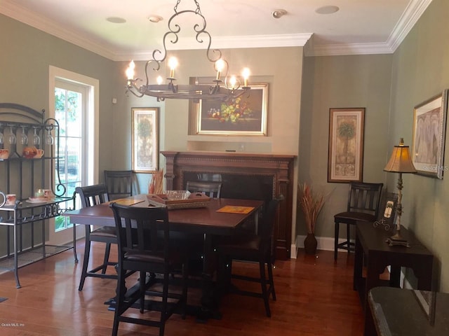 dining area with an inviting chandelier, dark hardwood / wood-style flooring, and ornamental molding