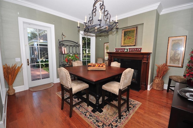 dining space with a chandelier, crown molding, dark wood-type flooring, and a wealth of natural light