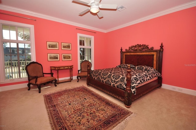 carpeted bedroom featuring crown molding and ceiling fan