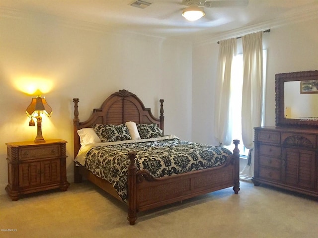 carpeted bedroom featuring ceiling fan and ornamental molding