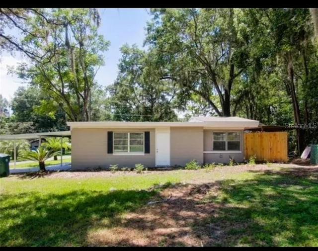 ranch-style house with a front lawn