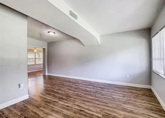 spare room featuring wood-type flooring