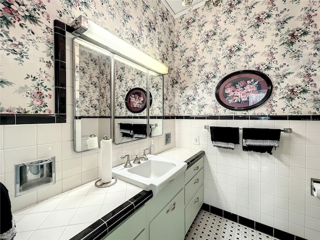 bathroom featuring tile flooring, large vanity, and tile walls