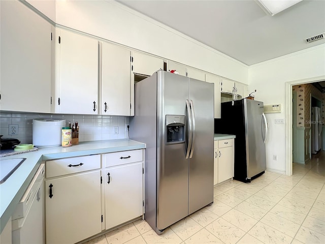 kitchen featuring stainless steel fridge, tasteful backsplash, white cabinets, and stainless steel refrigerator