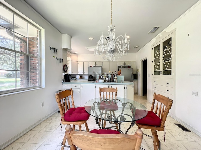 tiled dining space with a chandelier and a wealth of natural light