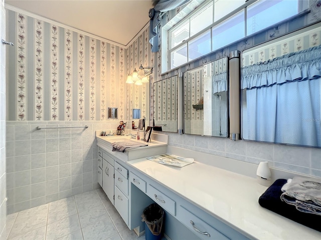 bathroom with tile walls, tile floors, and vanity