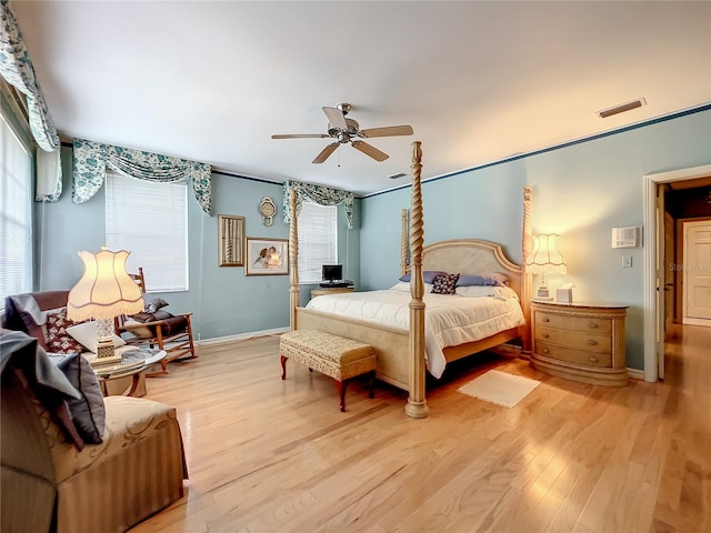 bedroom with ceiling fan, light wood-type flooring, and crown molding