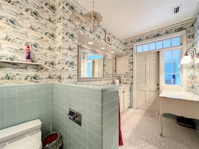 bathroom featuring tile walls, toilet, a healthy amount of sunlight, tile flooring, and vanity