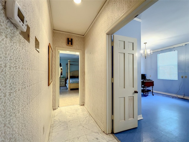 hall with an inviting chandelier, ornamental molding, and light tile floors